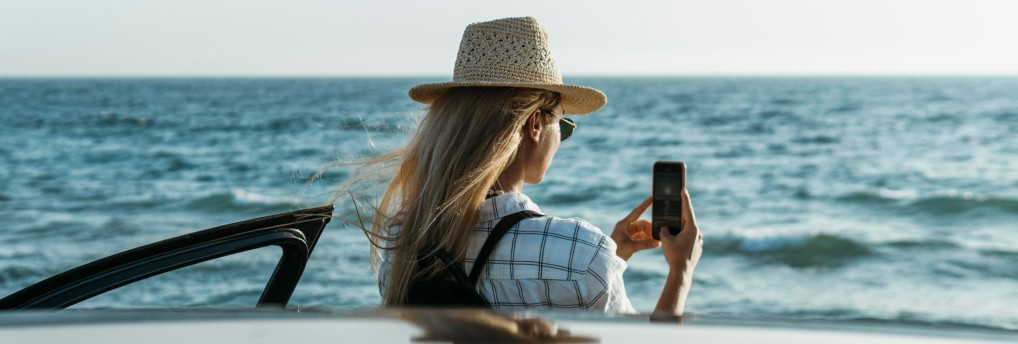 A woman is at the beach, rehydrated after IV drip therapy.