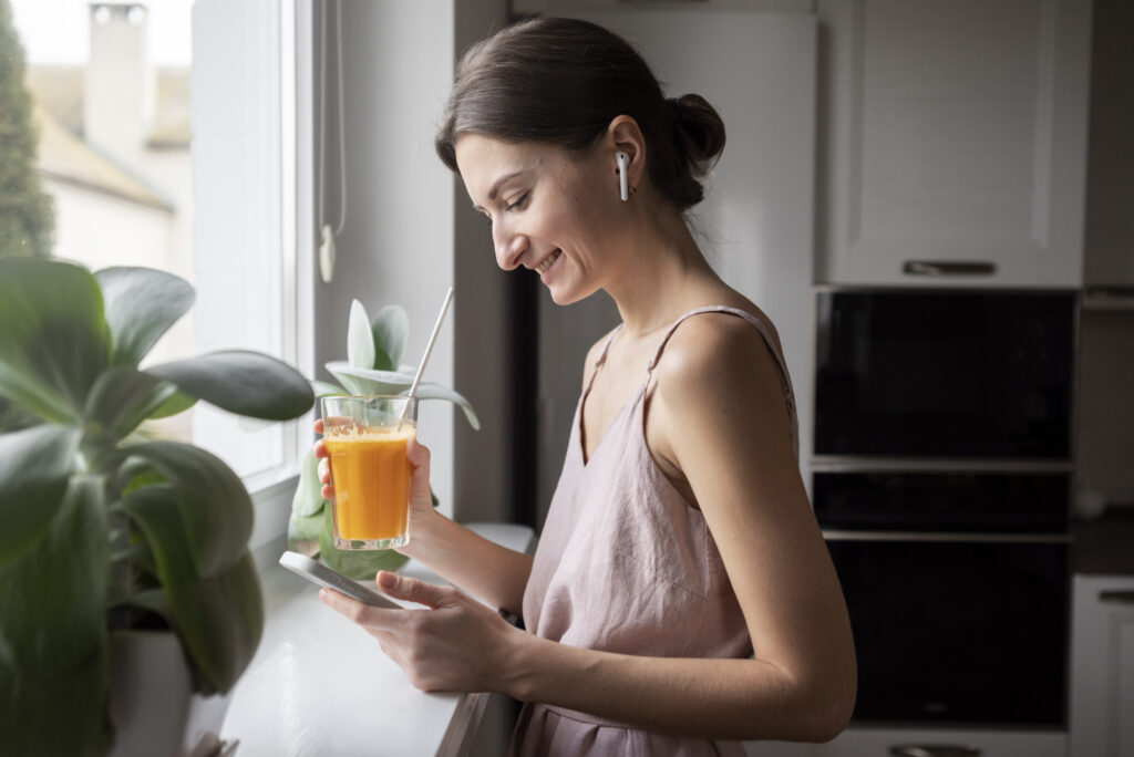 A woman is drinking orange juice and had an IV therapy to boost her immune system.